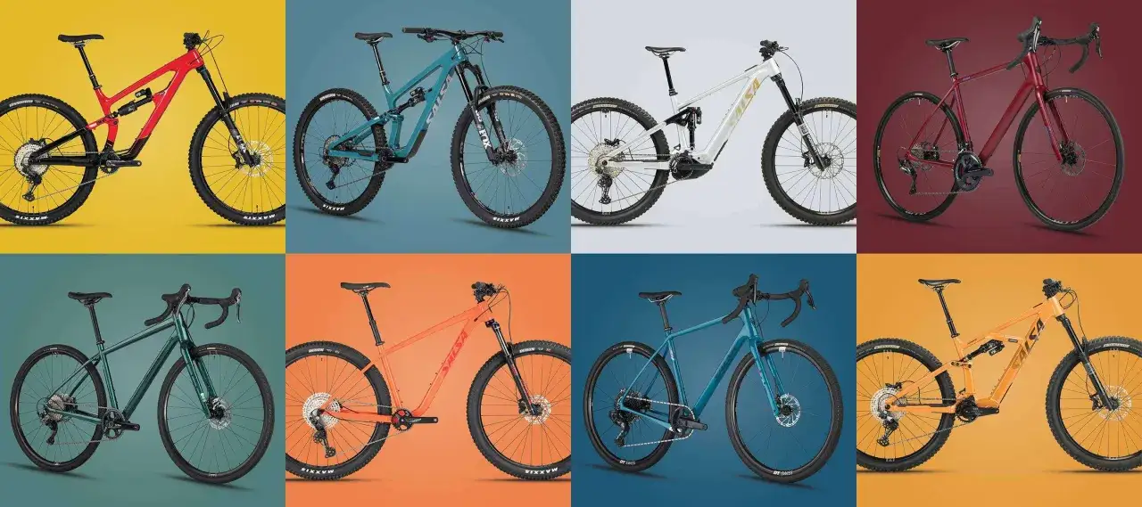Osiem rower&oacute;w: czerwony full-suspension, turkusowy full-suspension, biały elektryczny full-suspension, bordowy gravel, zielony gravel, pomarańczowy hardtail, niebieski gravel, pomarańczowy full-suspension. Jaki rower wybrać?