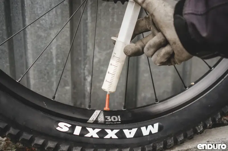 Rękawiczki i strzykawka z mleczkiem do opony tubeless.